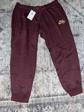 Nike women’s Maroon Sweatpants with Gold Logo